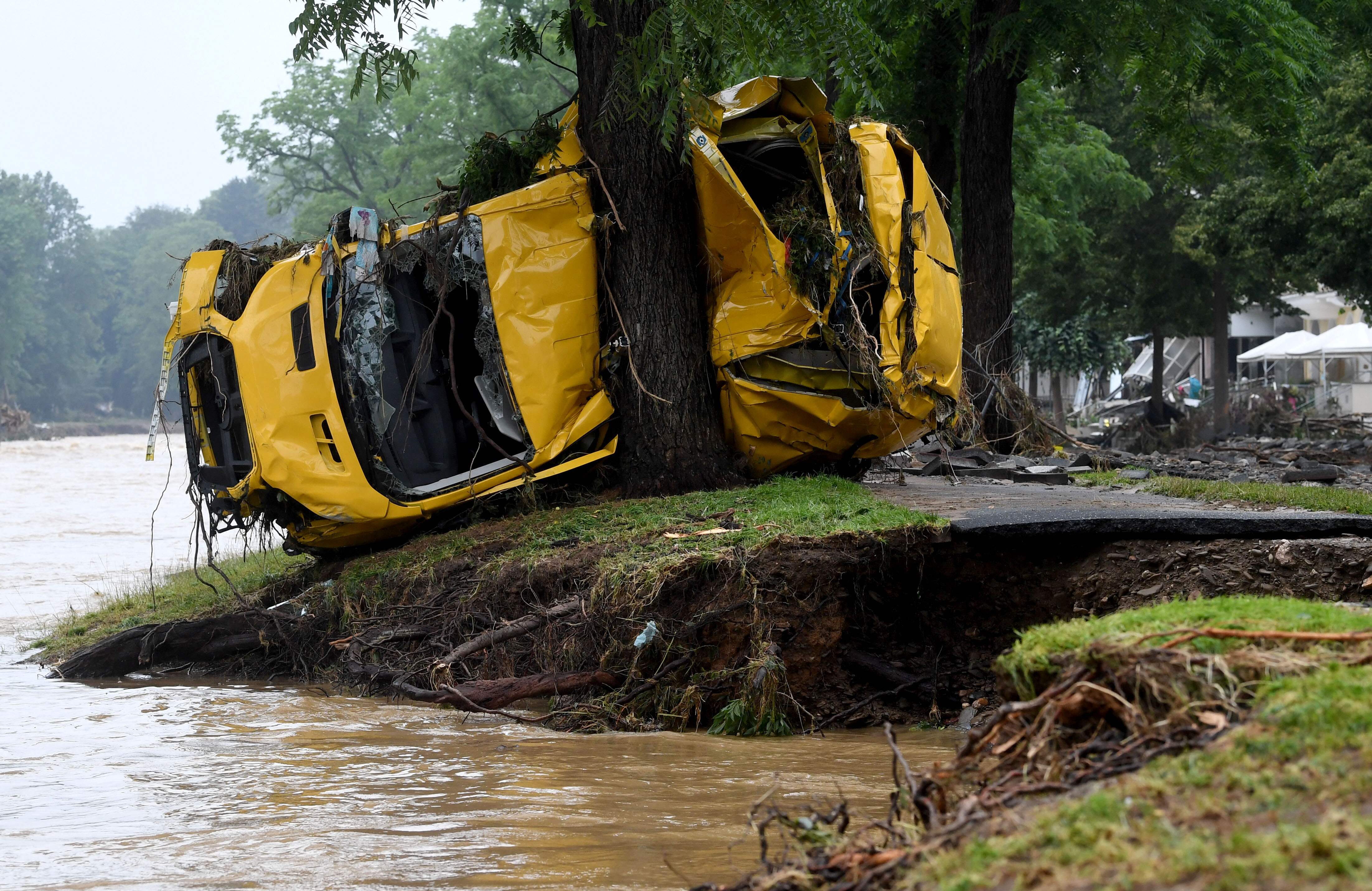 A van crushed by the torrents is wedged against a tree after the floods wreaked havoc in Bad Neuenahr-Ahrweiler, western Germany