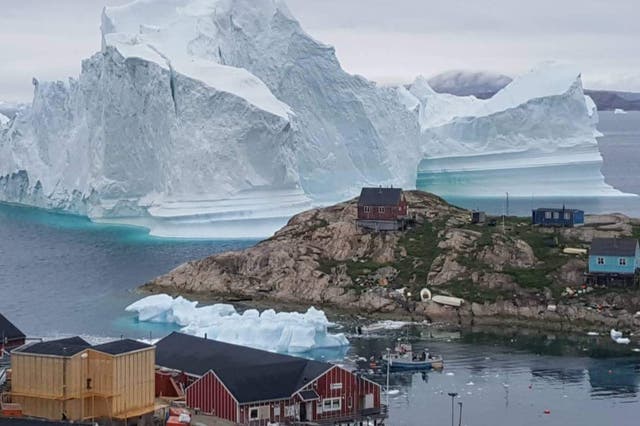 <p>An iceberg grounds  in north-western Greenland. Retreating ice could allow access to billions of gallons of oil</p>