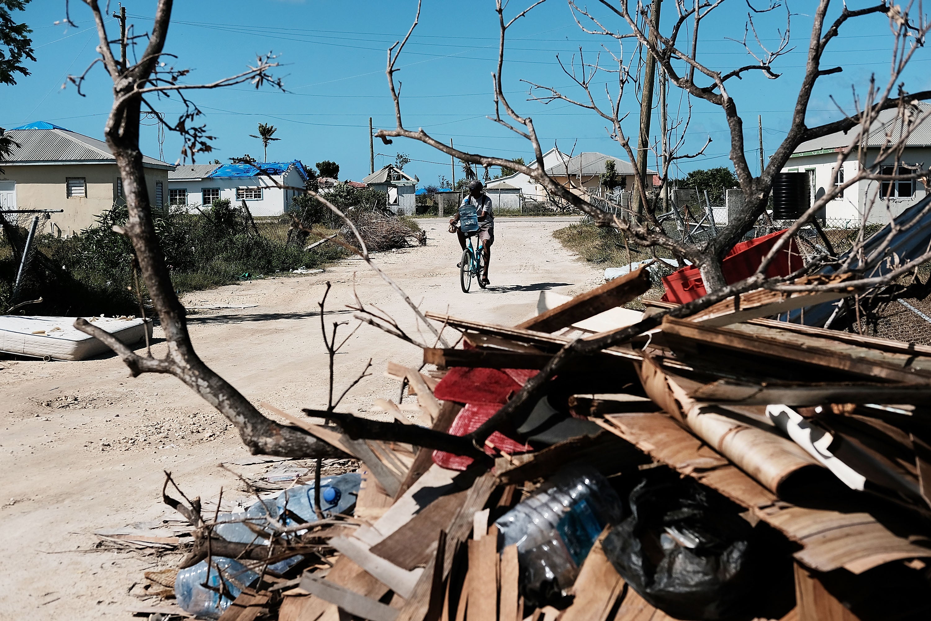 Debris from damaged homes lines a street on the nearly destroyed island of Barbuda on 8 December 2017 in Cordington, Barbuda.