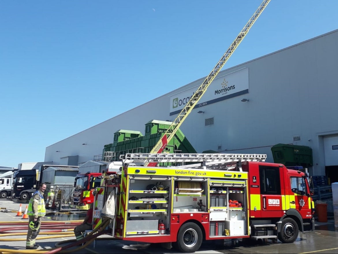 <p>Firefighters tackle a ‘very deep-seated’ blaze at the depot in Erith, south London</p>