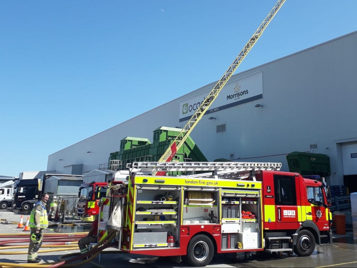 Firefighters tackle a ‘very deep-seated’ blaze at the depot in Erith, south London