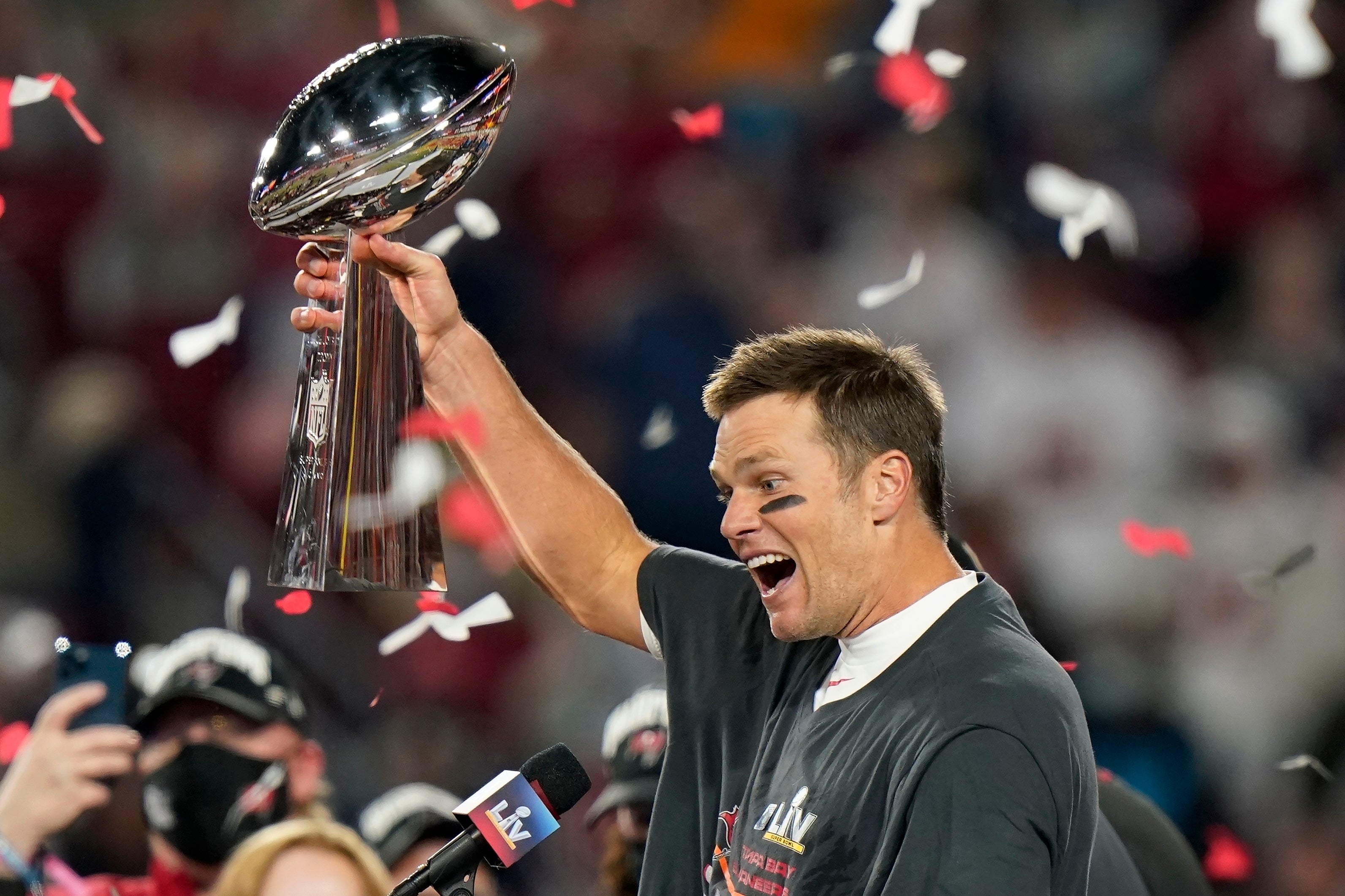 File. In this 7 February 2021 photo, Tampa Bay Buccaneers quarterback Tom Brady celebrates with the Vince Lombardi Trophy after the team's NFL Super Bowl 55 football game against the Kansas City Chiefs