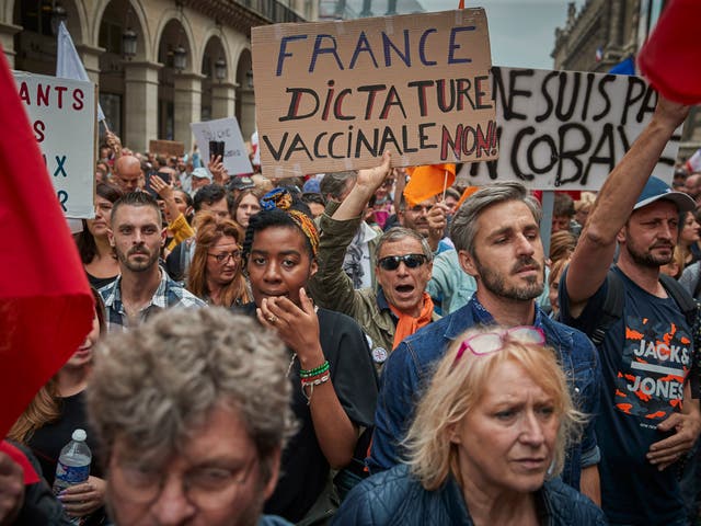 <p>Anti-vaccine protesters march through the streets of Paris</p>
