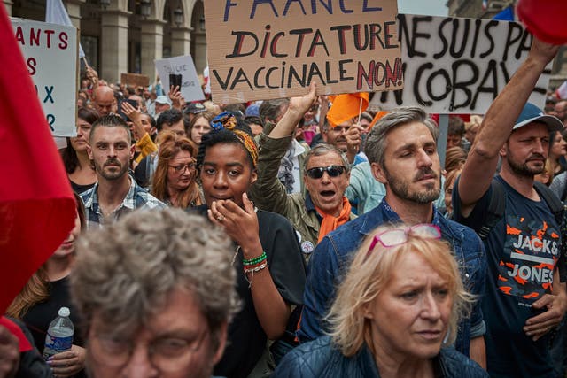 <p>Anti-vaccine protesters march through the streets of Paris</p>