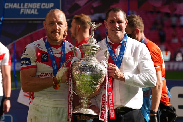 <p>St Helens’ James Roby (left) and head coach Kristian Woolf celebrate with the Challenge Cup trophy</p>