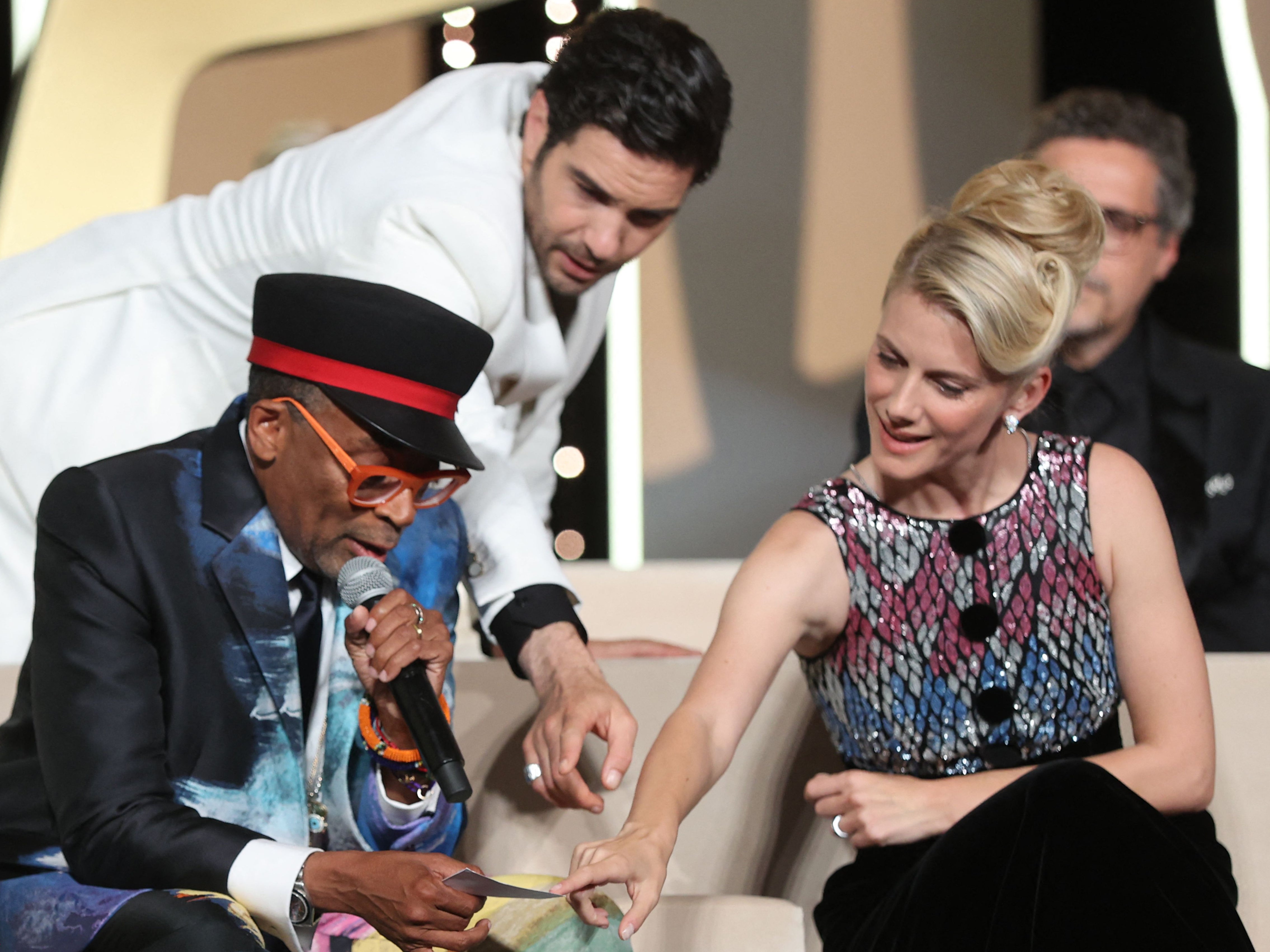 Spike Lee is helped out by Tahar Rahim and Mélanie Laurent at Cannes awards ceremony