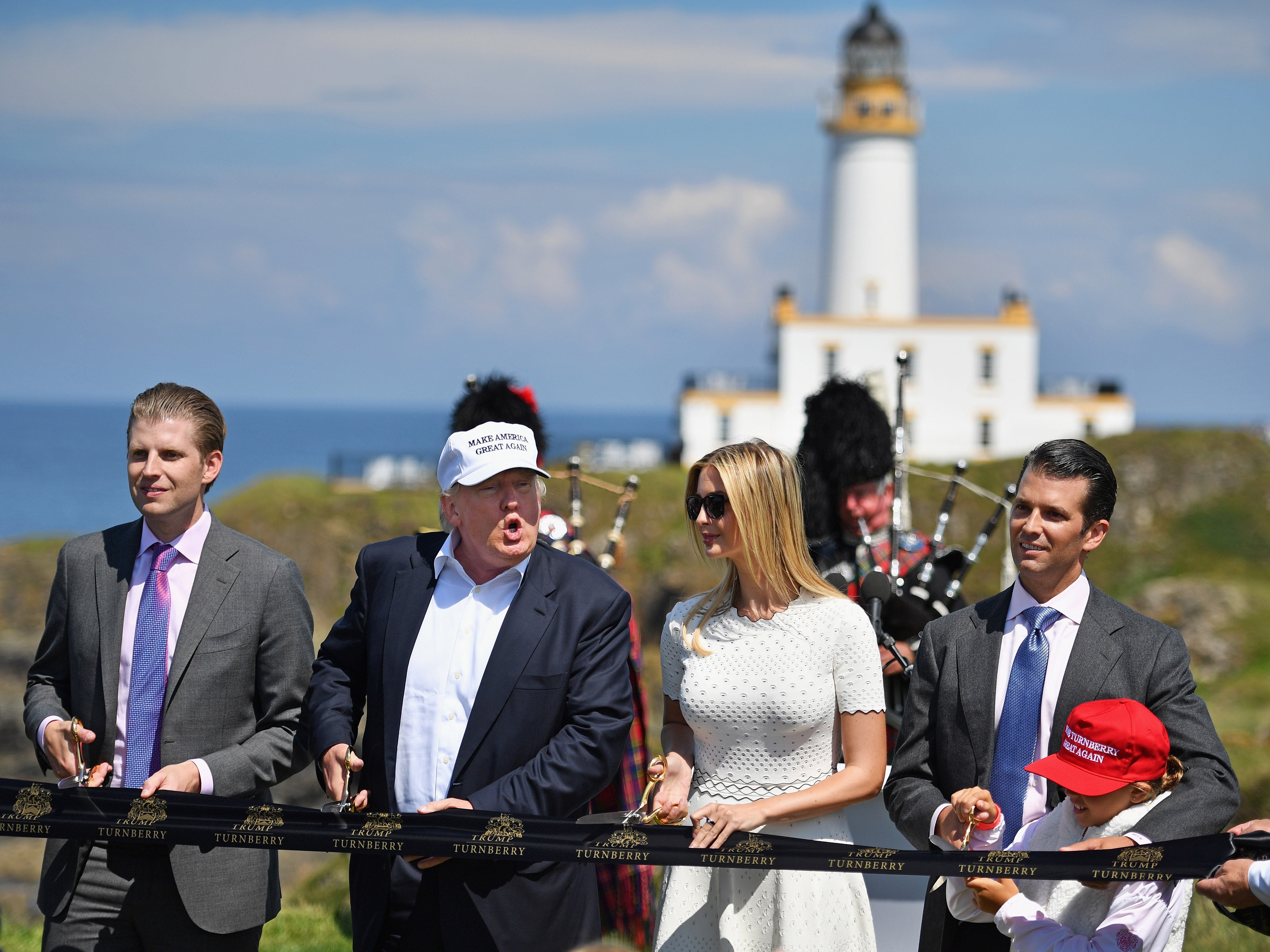 Donald Trump cuts a ribbon on the 9th tee at his Trump Turnberry Resort surrounded by Eric, Don Jr and Ivanka in 2016.