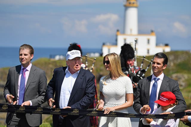 <p>Donald Trump cuts a ribbon at his Trump Turnberry Resort in Scotland with family in June 2016</p>