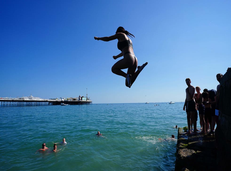 <p>People cool off in the sea at Brighton beach on the hottest day of 2021 so far</p>