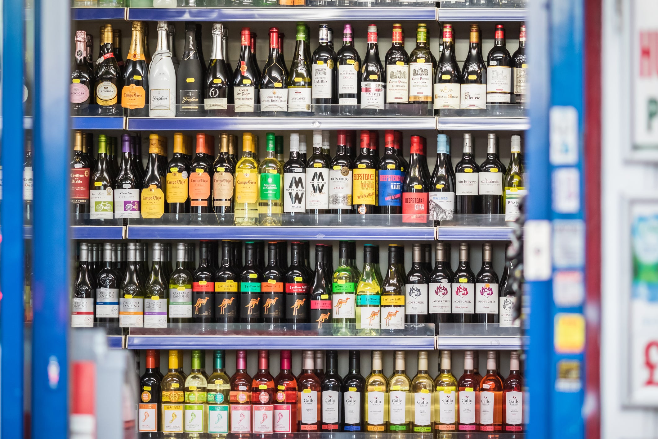 A selection of wines displayed on shelf in an off-licence shop