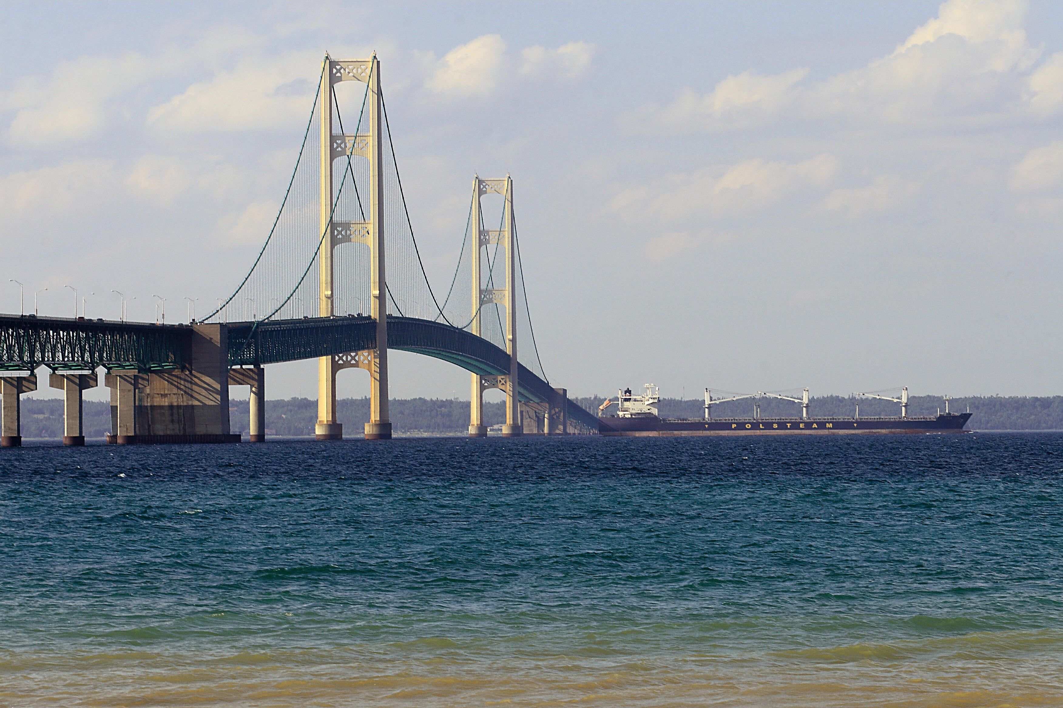 A ship is seen passing beneath the Mackinaw Bridge July 27, 2008 as seen from Mackinaw City, MI.The Mackinac Bridge straddles the Straits of Mackinac connecting Michigan's upper and lower peninsulas.