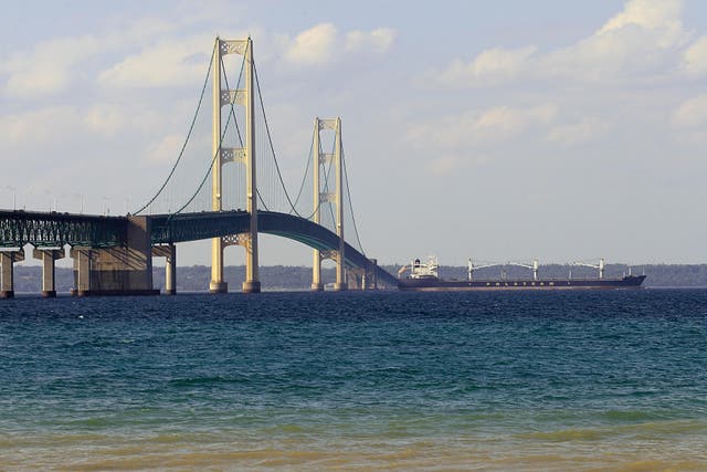 <p>A ship is seen passing beneath the Mackinaw Bridge July 27, 2008 as seen from Mackinaw City, MI.The Mackinac Bridge straddles the Straits of Mackinac connecting Michigan's upper and lower peninsulas.</p>