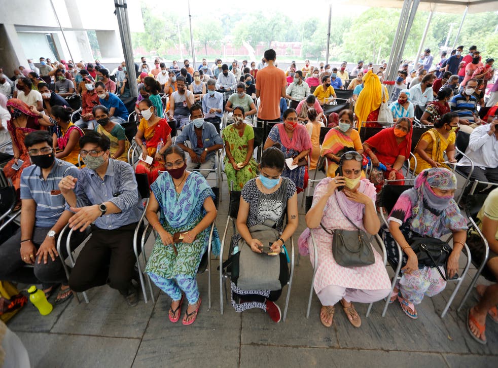 <p>People wait for their turn to get vaccinated at a centre in India’s Ahmedabad city on 16 July, 2021</p>
