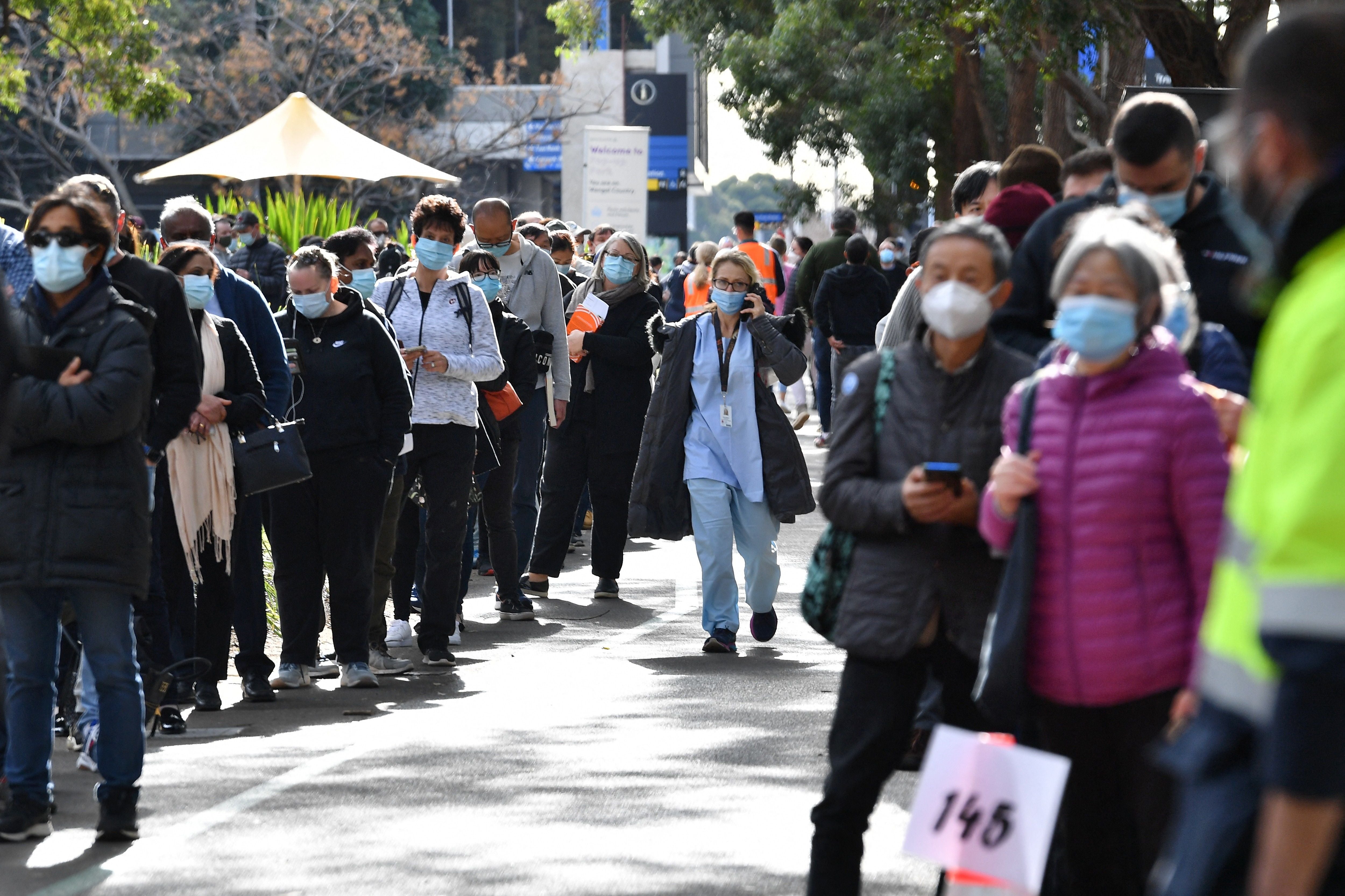 Sydneysiders wait in a queue outside a Covid-19 vaccination centre in the Homebush suburb of Sydney on 7 July 2021