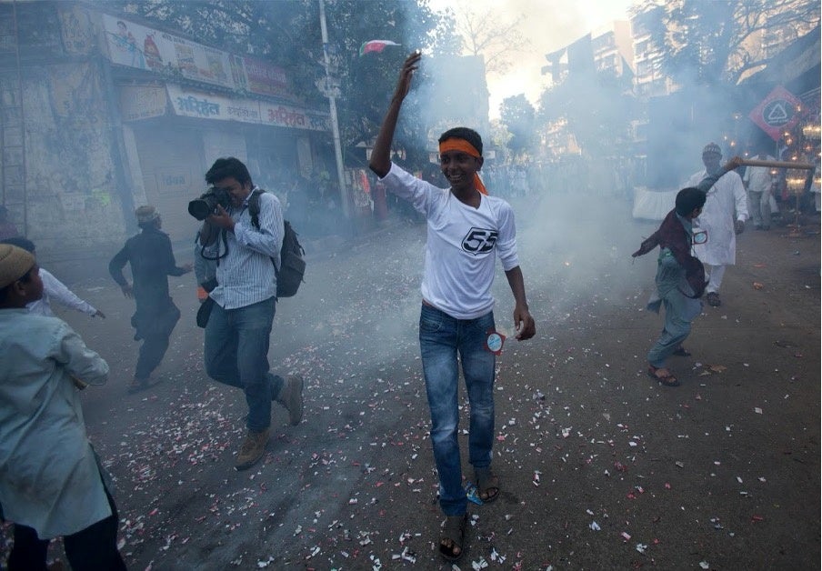 Danish Siddiqui takes pictures as fireworks explode during a procession to mark Eid-e-Milad-ul-Nabi, birthday celebrations for the Prophet Mohammad, in Mumbai, India, in 2011