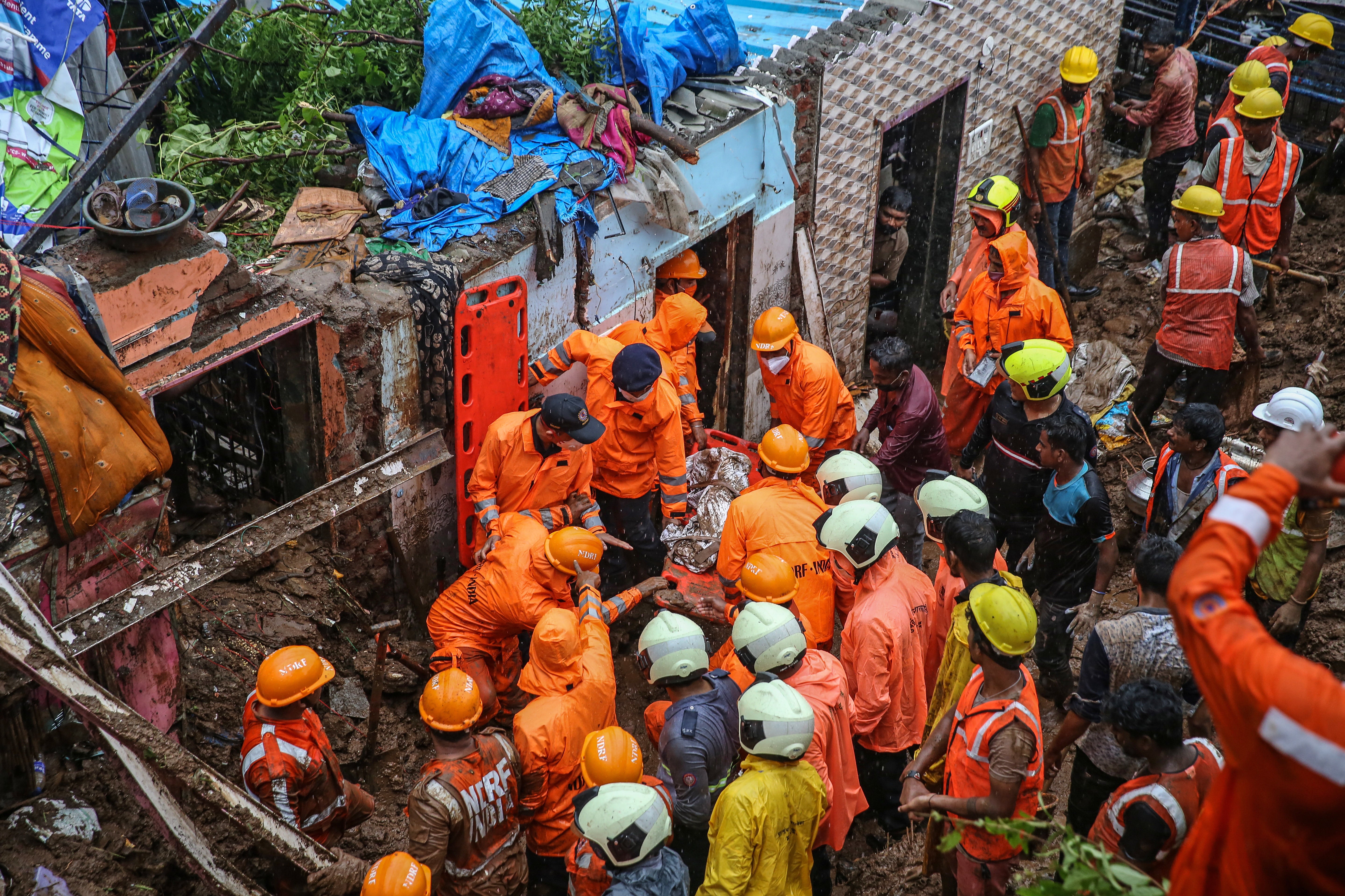 <p>National Disaster Response Force personnel during a rescue operation after a landslide in Chembur area of Mumbai on 18 July</p>