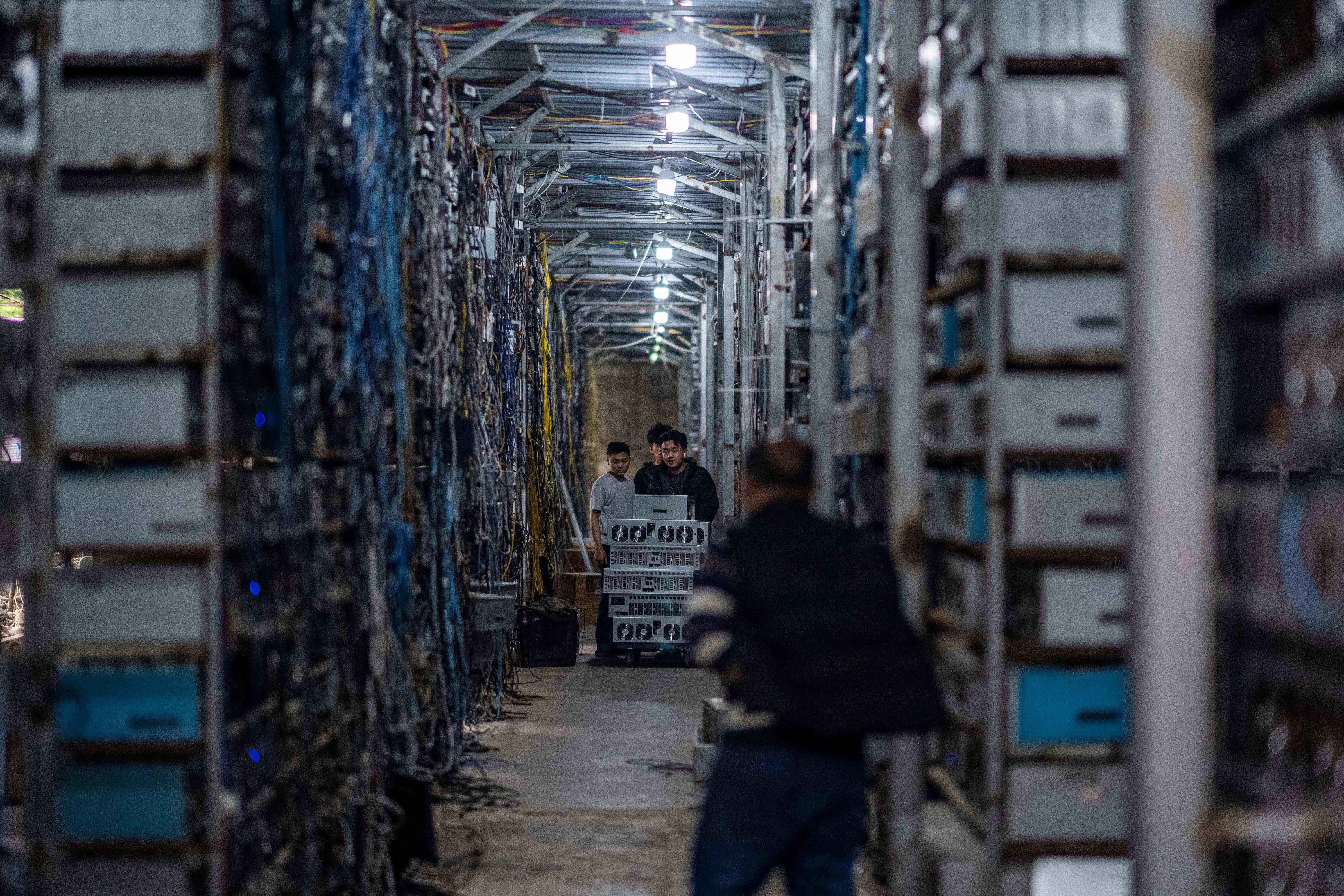 Workers transferring cryptocurrency mining rigs in Dujiangyan in China’s southwestern Sichuan province
