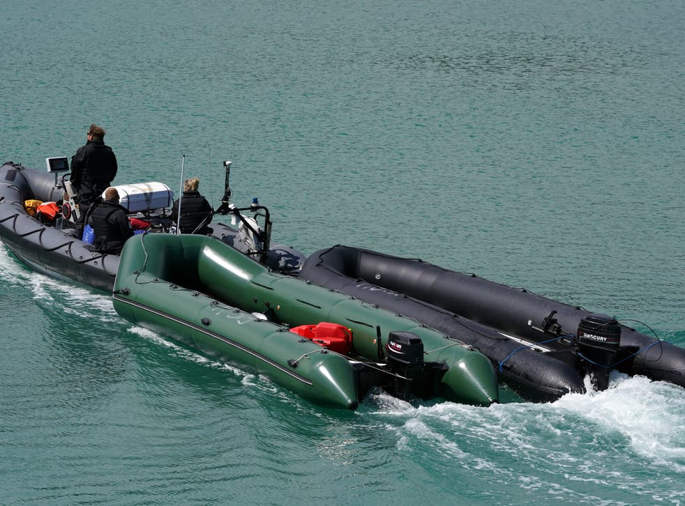 This file photo from July shows boats thought to be used in migrant crossings are towed by Border Force officers into Dover, Kent