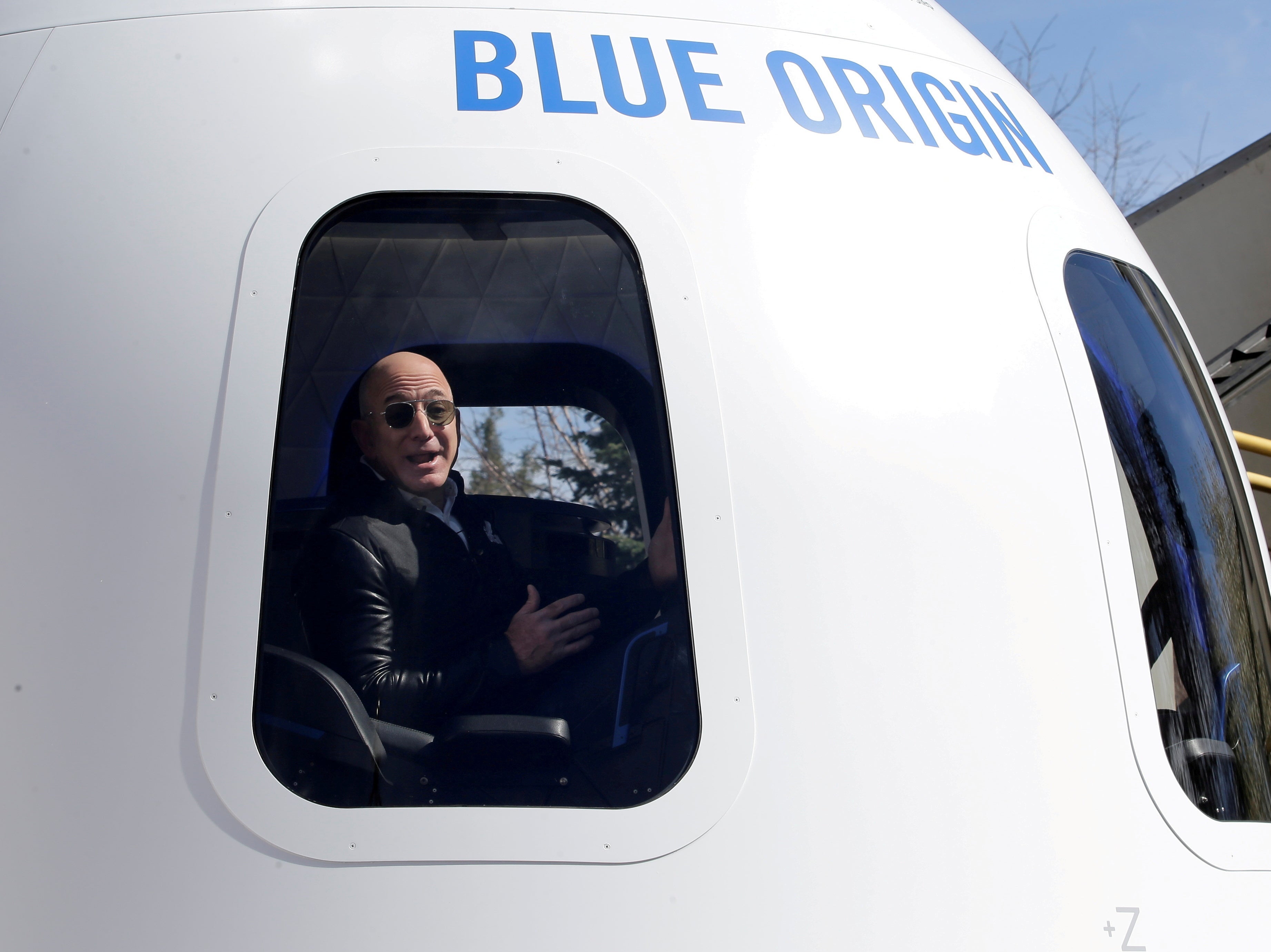 Jeff Bezos addresses the media from inside Blue Origin