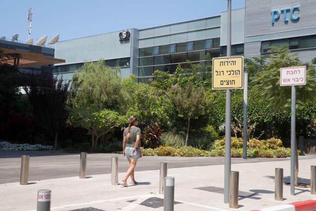 <p>A woman walks outside the building housing the Israeli NSO group ‘Pegasus’, in Herzliya, near Tel Aviv </p>
