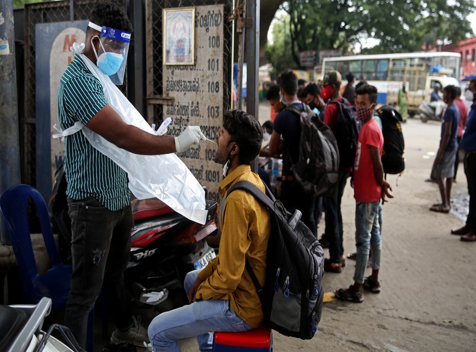 <p>A health worker takes a nasal and throat swab sample for a Covid-19 test in India’s Bengaluru city on 19 July, 2021</p>
