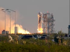 Jeff Bezos hugs his girlfriend Lauren Sanchez and family after Blue Origin space flight