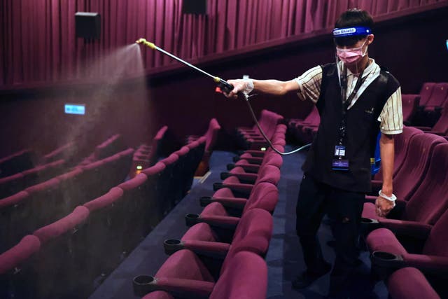 <p>A staff disinfects the seats as cinemas reopen after Central Epidemic Command Center (CECC) eased coronavirus disease restrictions</p>