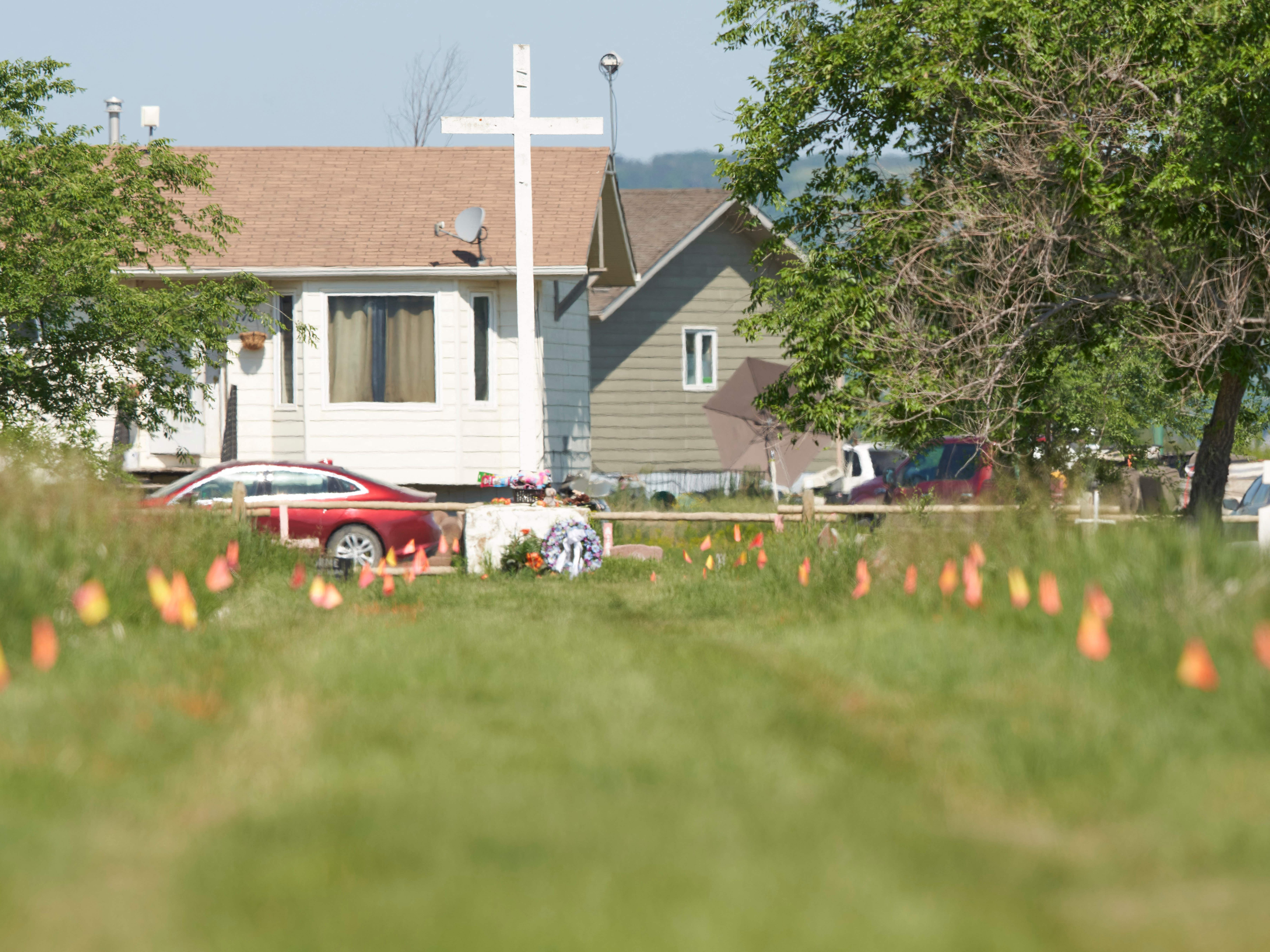 <p>Flags mark the spot where the remains of over 750 children were buried on the site of the former Marieval Indian Residential School in Cowessess first Nation, Saskatchewan, June 25, 2021</p>