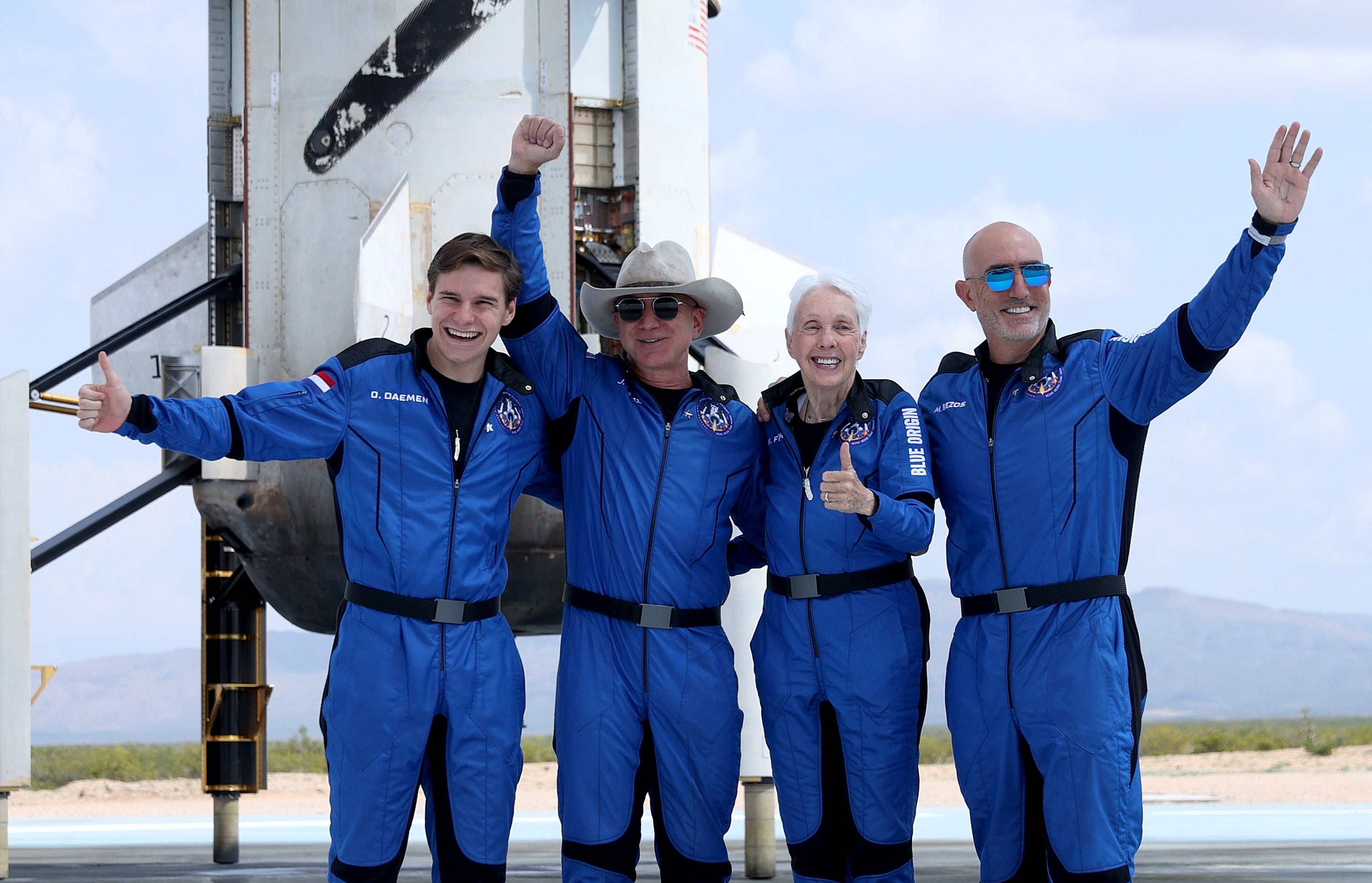 <p>Blue Origin’s New Shepard crew (L-R) Oliver Daemen, Jeff Bezos, Wally Funk, and Mark Bezos pose for a picture near the booster after flying into space in the Blue Origin New Shepard rocket on July 20, 2021 in Van Horn, Texas. </p>