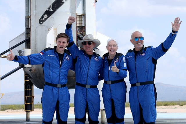 <p>Blue Origin’s New Shepard crew (L-R) Oliver Daemen, Jeff Bezos, Wally Funk, and Mark Bezos pose for a picture near the booster after flying into space in the Blue Origin New Shepard rocket on July 20, 2021 in Van Horn, Texas. </p>