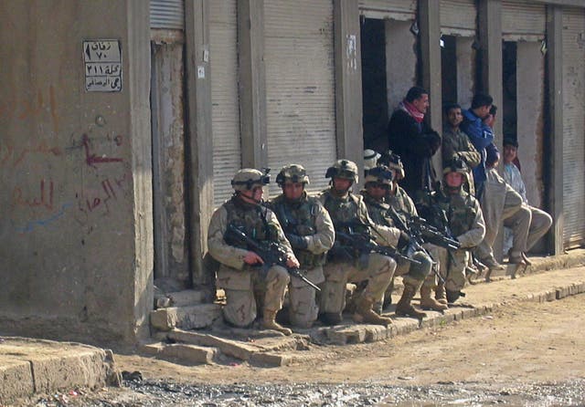 <p>US soldiers raid a neighbourhood in the flashpoint Iraqi town of Fallujah, on 2 January 2004</p>
