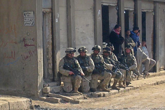 <p>US soldiers raid a neighbourhood in the flashpoint Iraqi town of Fallujah, on 2 January 2004</p>