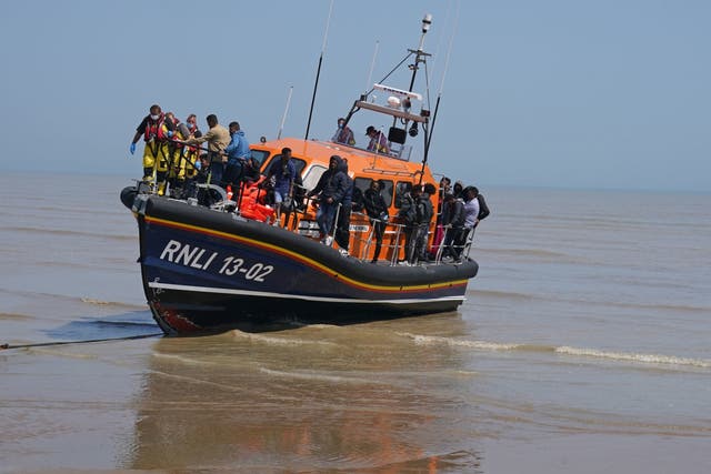 <p>A group of people thought to be migrants crossing from France are brought ashore by the local lifeboat at Dungeness, Kent</p>