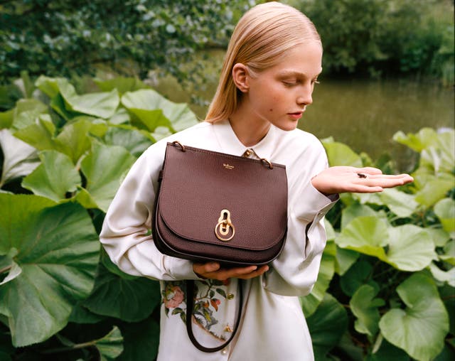 A model holds a Mulberry handbag