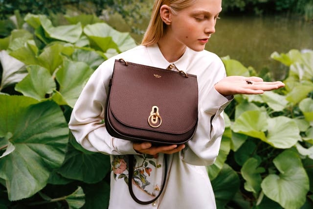A model holds a Mulberry handbag