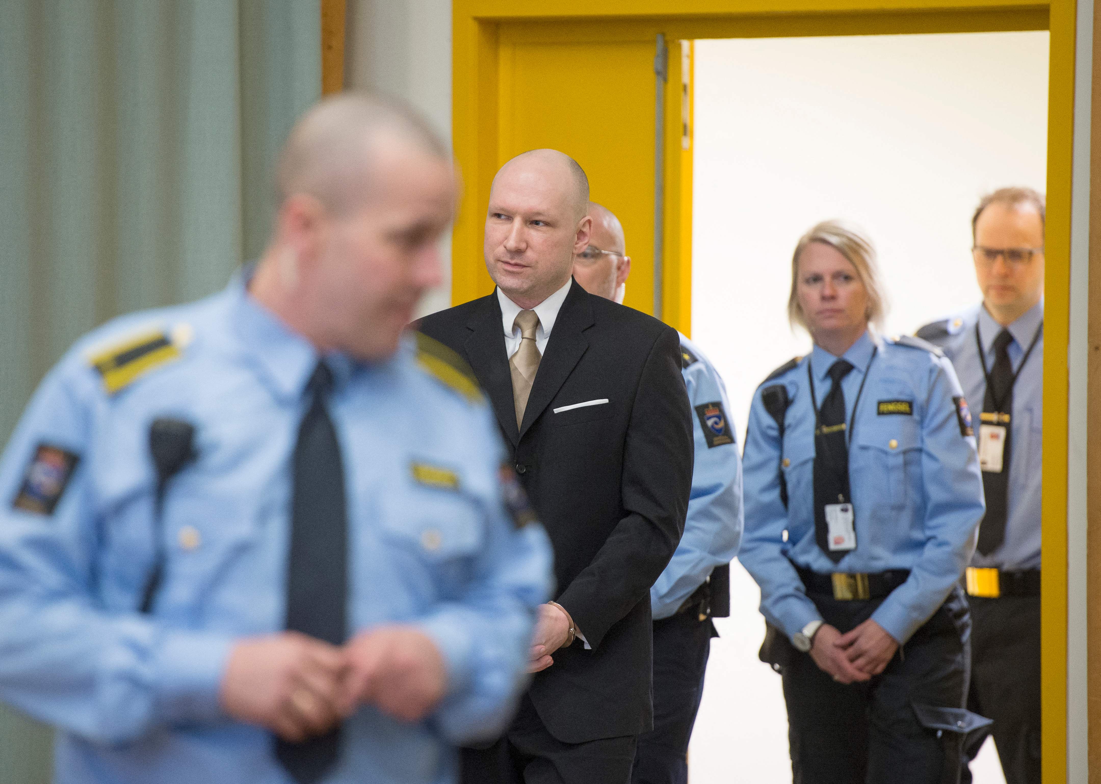 Anders Behring Breivik enters a makeshift court in Skien prisons gym on 15 March 2016