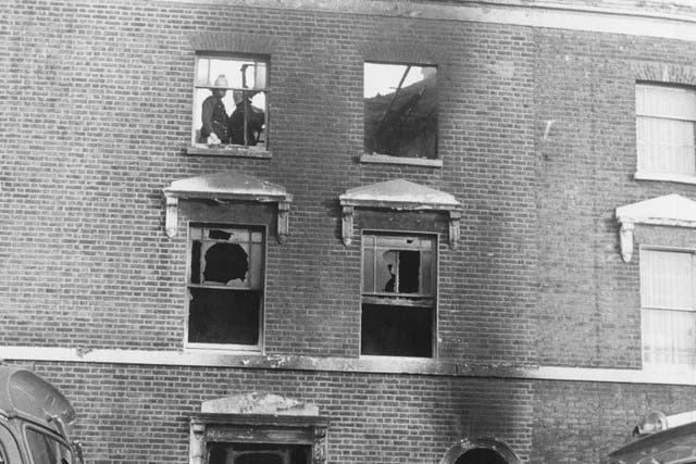 <p>Firefighters at 439 New Cross Road, south London, the day after a fire killed 13 young Black people. Many believed the blaze was caused by a racist attack</p>