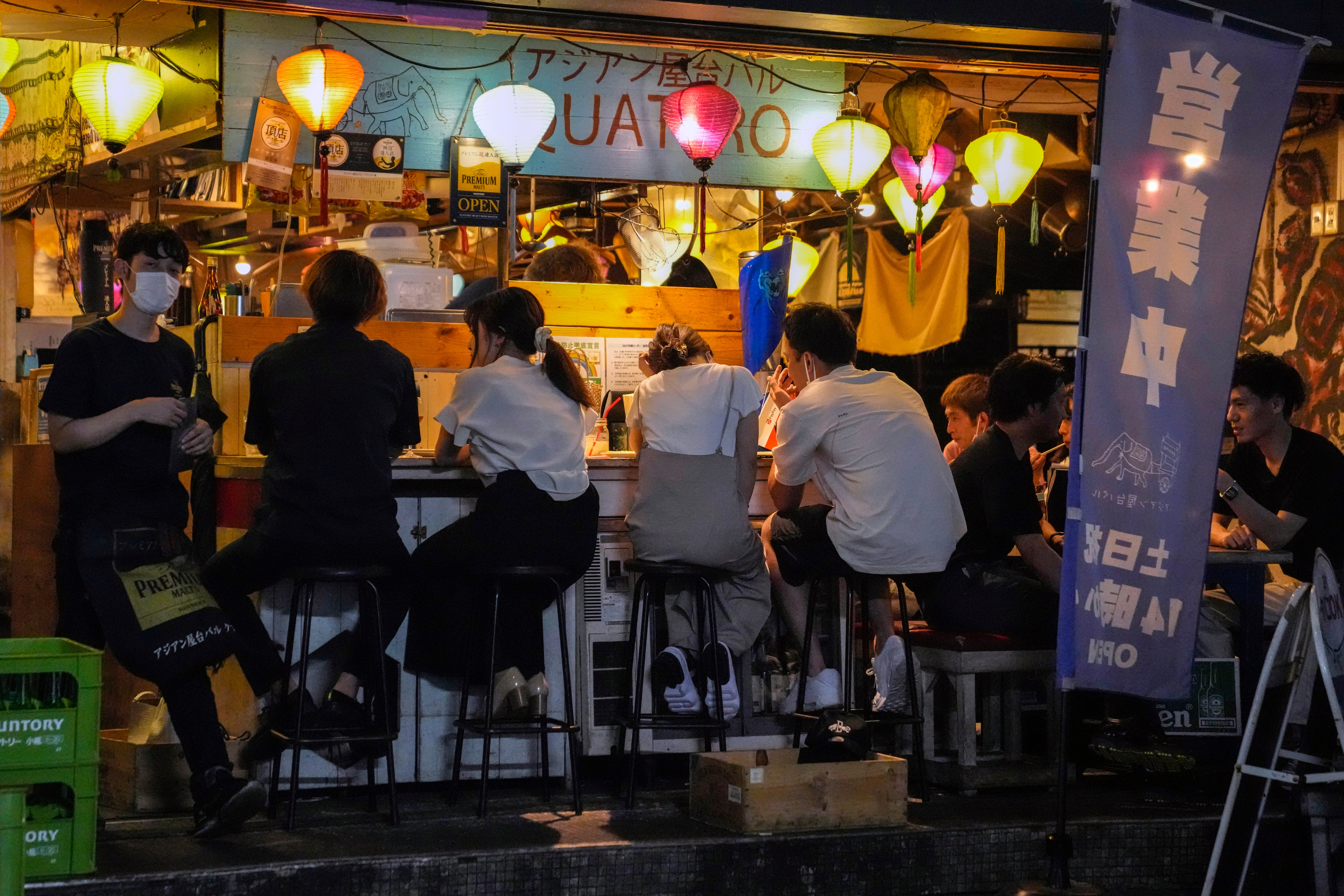 People gather at a bar despite a government-imposed 8pm closing time for restaurants and bars under Tokyo’s fourth state of emergency