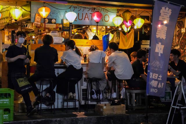<p>People gather at a bar despite a government-imposed 8pm closing time for restaurants and bars under Tokyo’s fourth state of emergency</p>