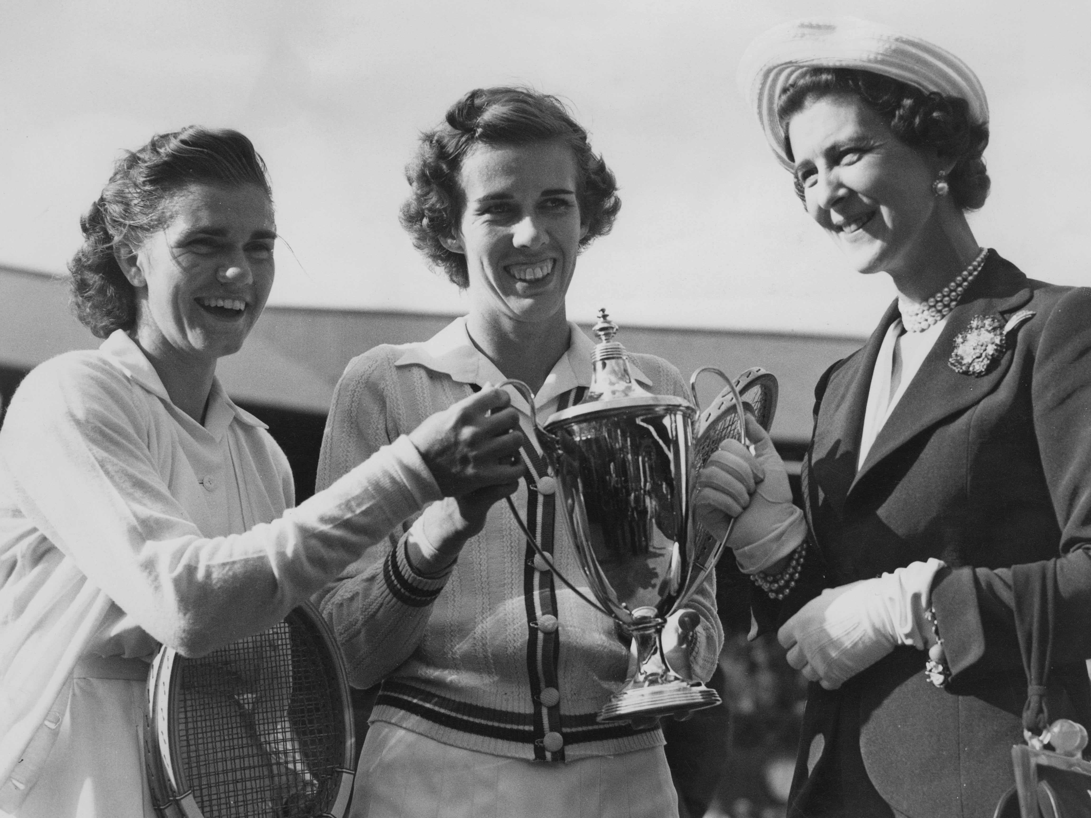 The Duchess of Kent (right) presents the Wimbledon trophy to Fry (left) and Doris Hart (centre)