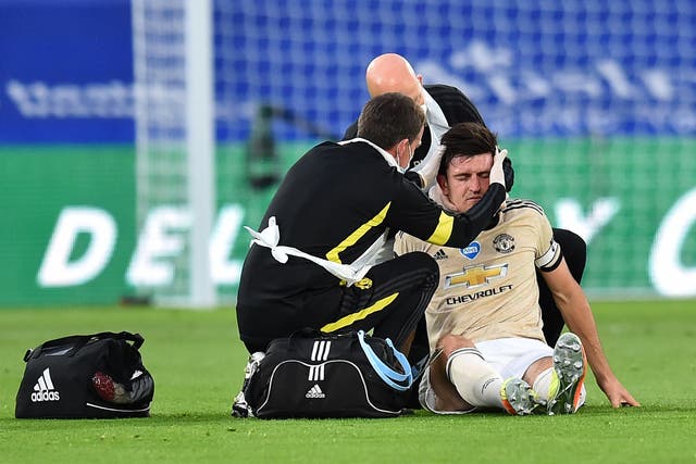 Manchester United’s Harry Maguire receives treatment for a head and neck injury on the pitch during a match against Crystal Palace