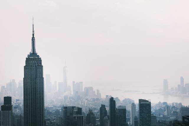 <p>The  Manhattan skyline continues to sit under a haze on 21 July</p>
