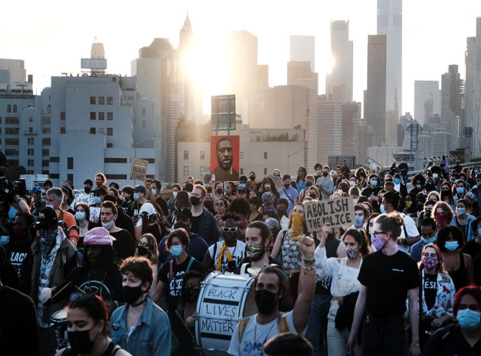 <p>Black Lives Matter supporters and others march in New York City on 25 May, in honour of George Floyd on the one year anniversary of his death</p>