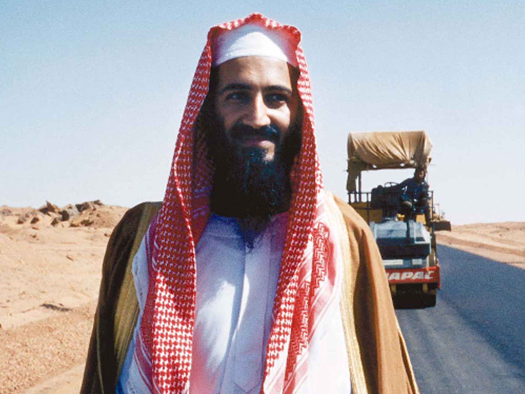 Bin Laden poses by his new desert road, Sudan, 1993
