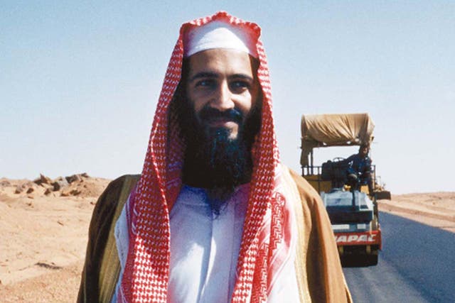 <p>Bin Laden poses by his new desert road, Sudan, 1993</p>