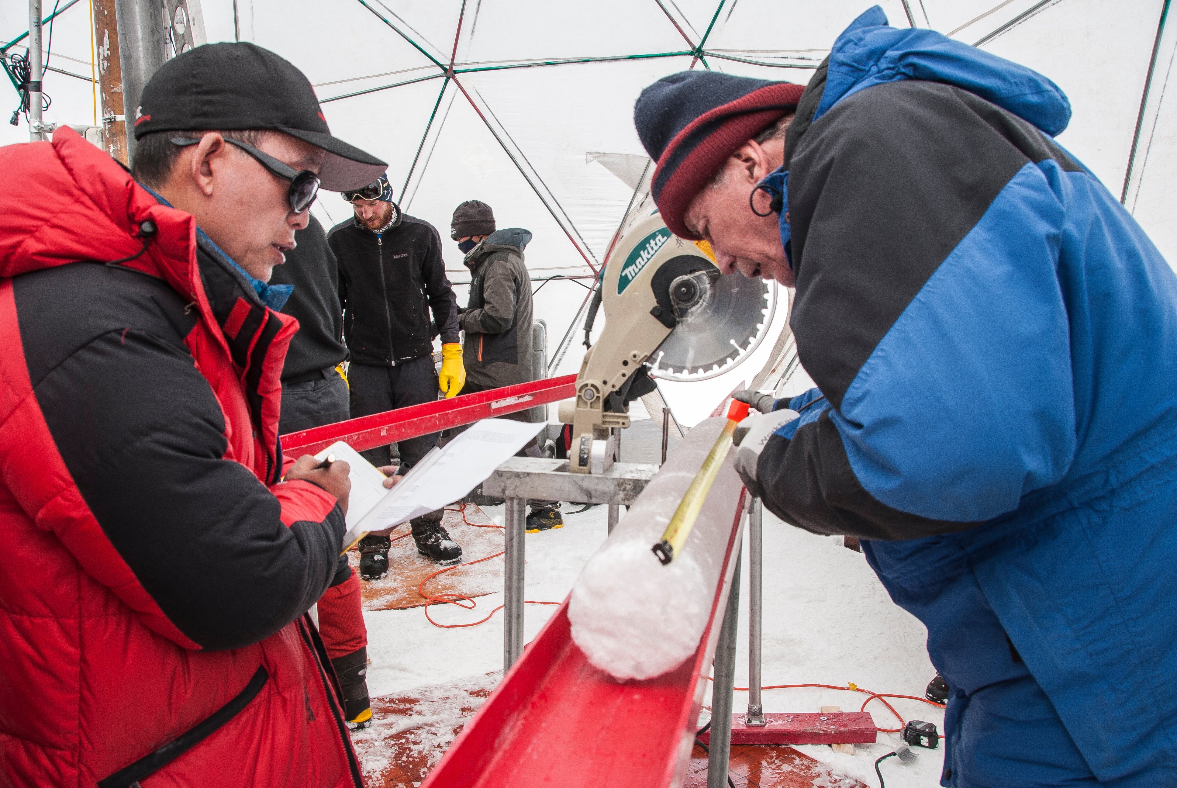 Yao Tandong, left, and Lonnie Thompson process an ice core drilled from the Tibetan Plateau in 2015