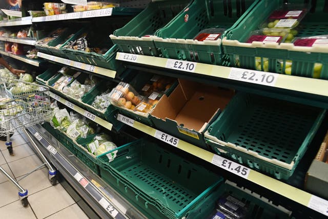 <p>Half-empty shelves at a supermarket in London</p>