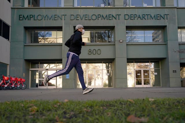 <p>Aa runner passes the office of the California Employment Development Department</p>