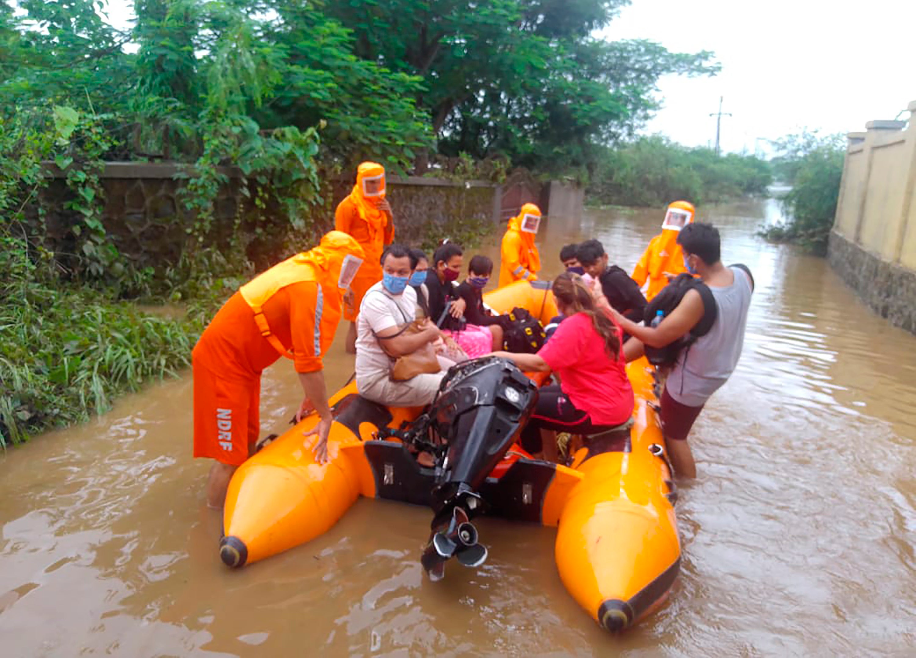 <p>Photo provided by India’s National Disaster Response Force shows its personnel rescuing stranded people in Maharashtra on 22 July, 2021</p>