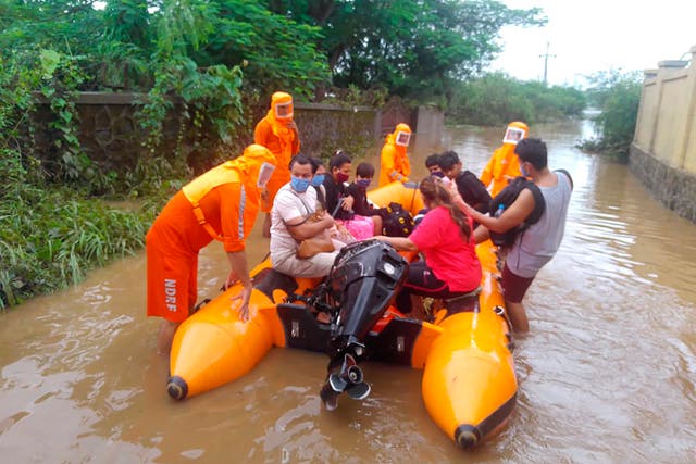 <p>Photo provided by India’s National Disaster Response Force shows its personnel rescuing stranded people in Maharashtra on 22 July, 2021</p>